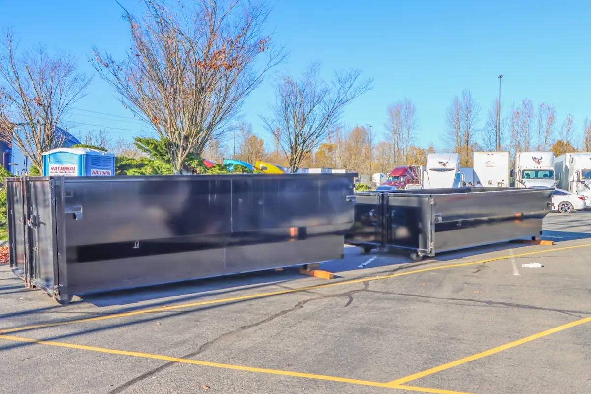 Professional dumpster rental service with roll-off container on residential driveway in Dunedin